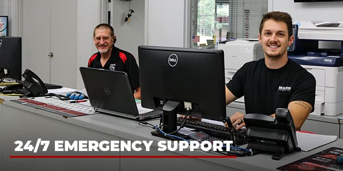 two behler-young employees at the branch counter smiling